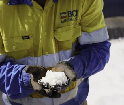 Mine worker holding evaporated salt